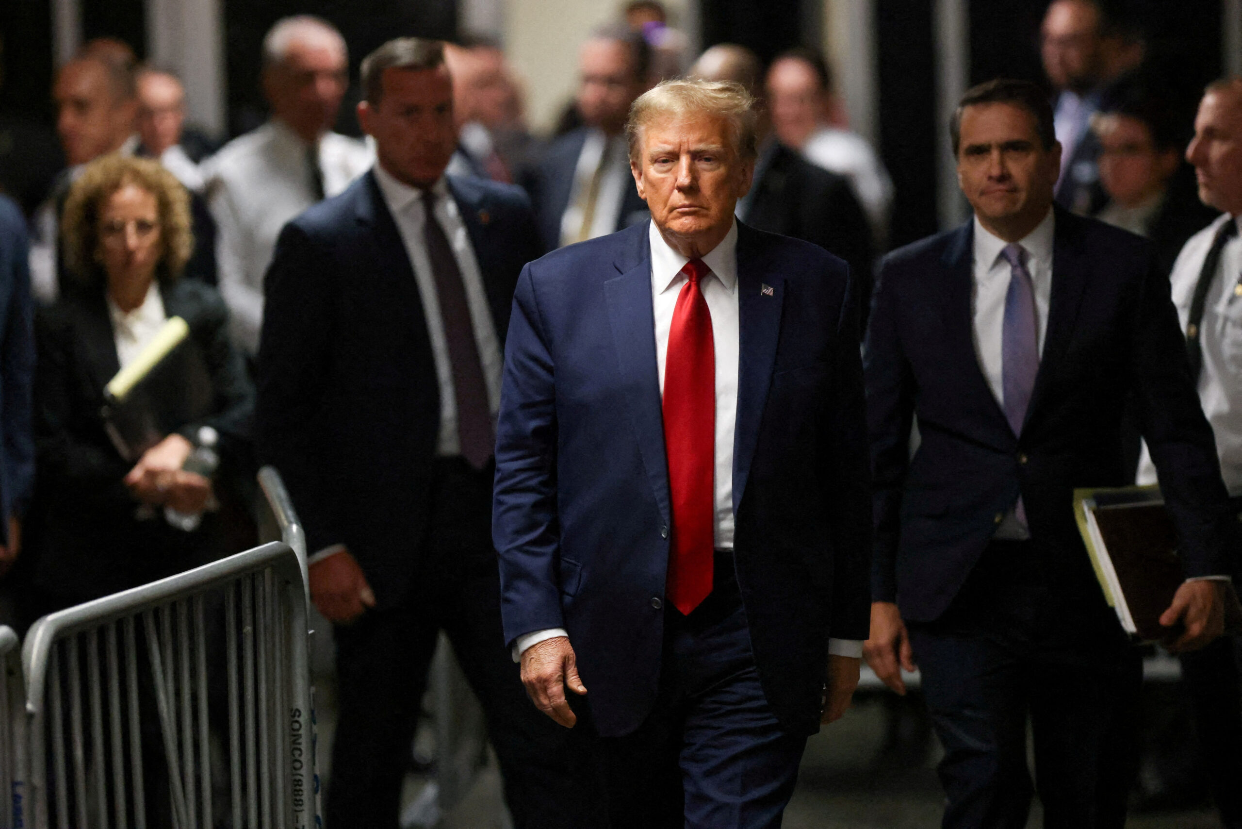 FILE PHOTO: Former U.S. President Donald Trump walks outside the courtroom on the day of a court hearing on charges of falsifying business records to cover up a hush money payment to a porn star before the 2016 election, in New York State Supreme Court in the Manhattan borough of New York City, U.S., February 15, 2024. REUTERS/Andrew Kelly/File Photo