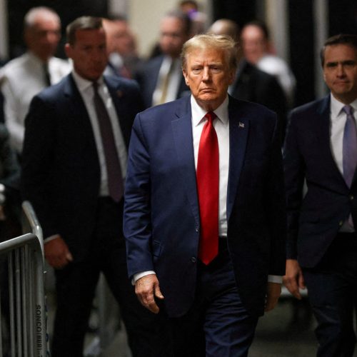 FILE PHOTO: Former U.S. President Donald Trump walks outside the courtroom on the day of a court hearing on charges of falsifying business records to cover up a hush money payment to a porn star before the 2016 election, in New York State Supreme Court in the Manhattan borough of New York City, U.S., February 15, 2024. REUTERS/Andrew Kelly/File Photo